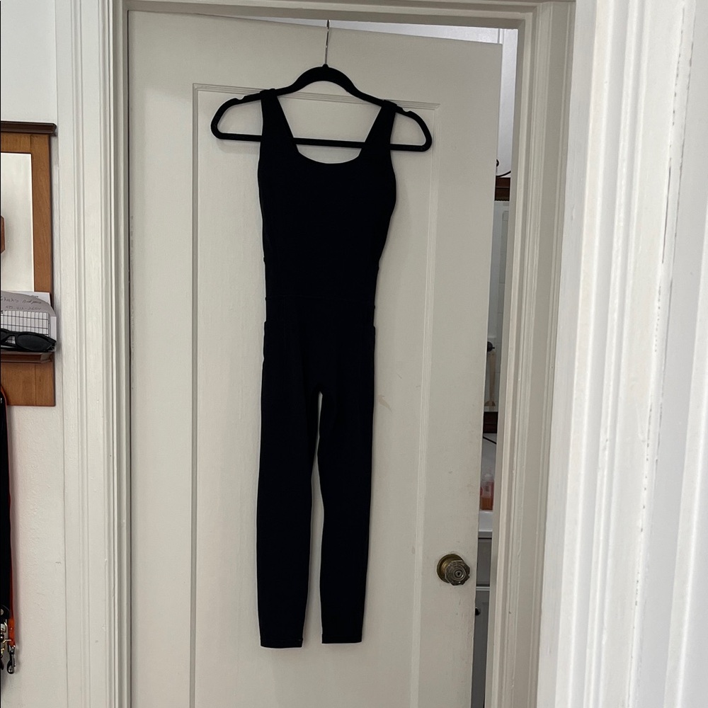 Athleta black jumpsuit with pockets and built in bra